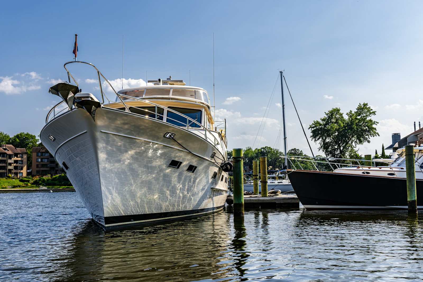 Polished luxury yacht docked at a sunny marina